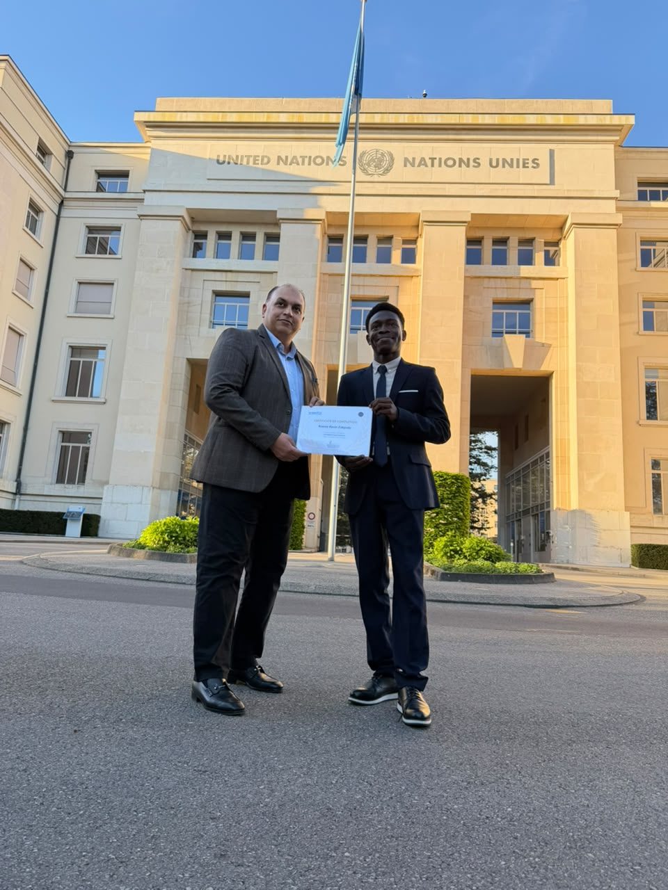 Koessi Kevin Zokpodo receiving a certificate in front of the Palais des Nations